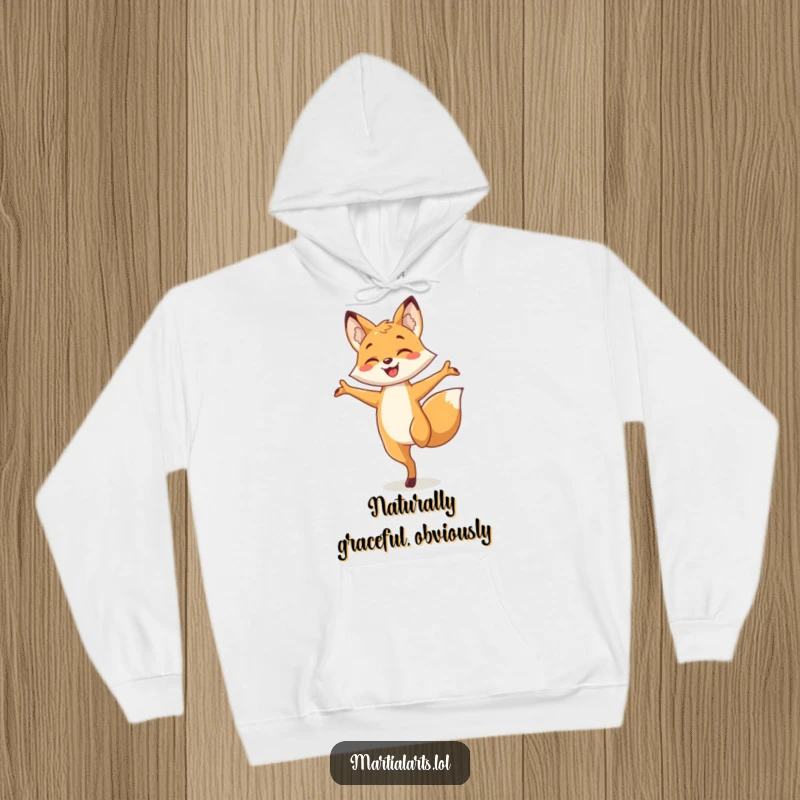 Funny fox hoodie depicting a smiling fox elegantly balancing on one leg, arms out, radiating calm and playful energy.